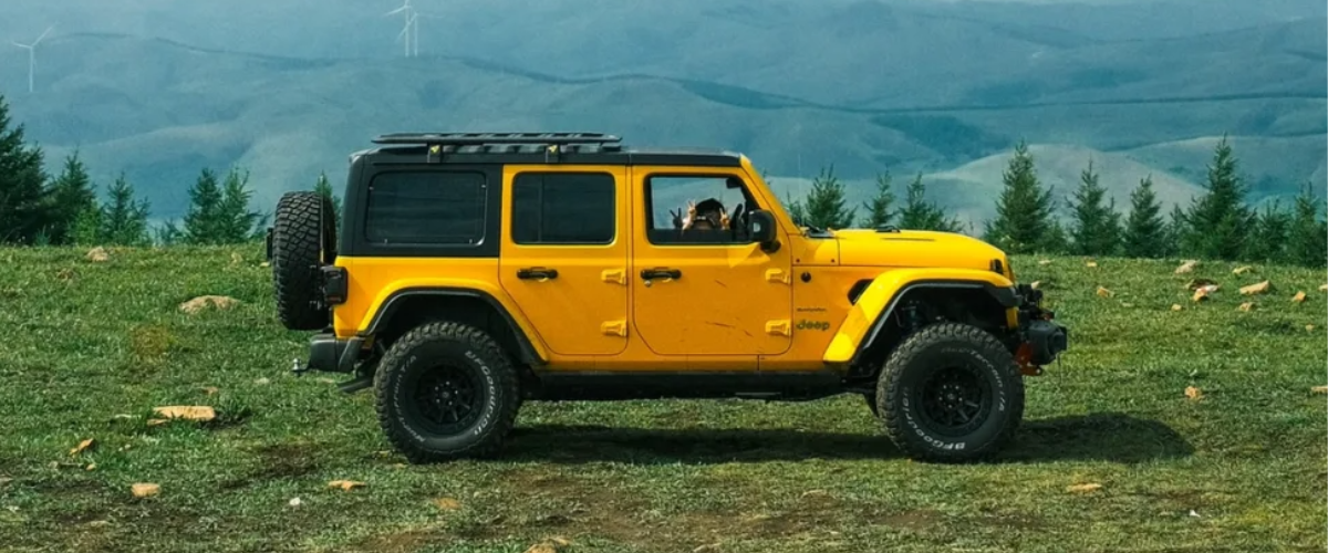 A Jeep Wrangler Unlimited with yellow vinyl wrap